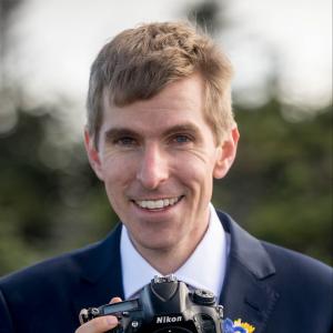 Scott Wehrwein Headshot holding camera